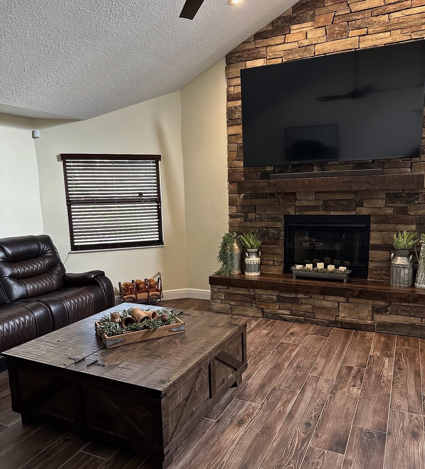 Living room with stone fireplace and custom coffee table