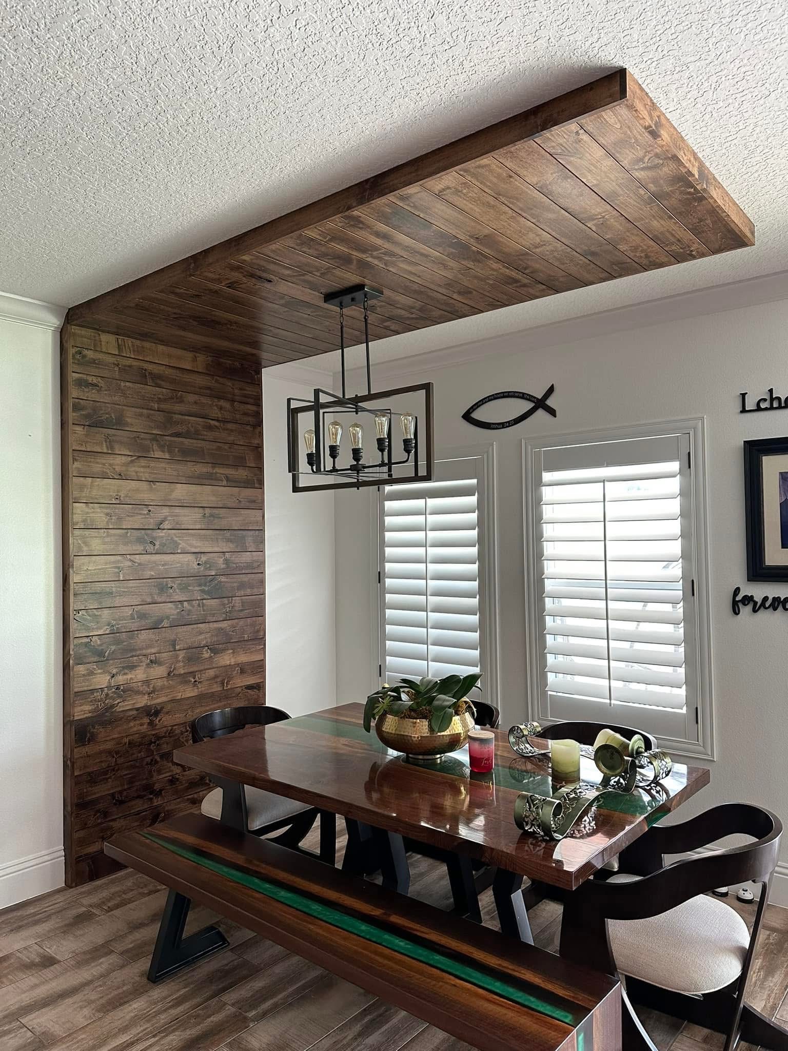 Reclaimed wood accent wall and ceiling in dining room