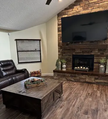Living room with stone fireplace and custom coffee table