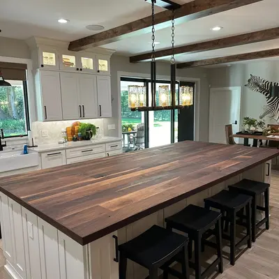 Custom walnut kitchen island with exposed beams