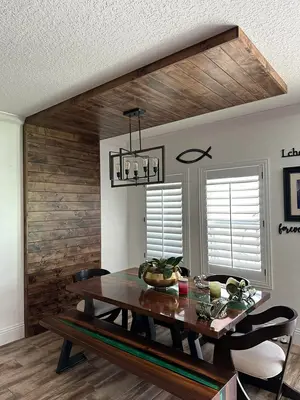 Reclaimed wood accent wall and ceiling in dining room